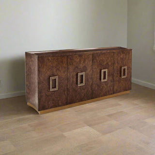 The Elwyn Credenza is a refined, sophisticated piece that blends rustic and contemporary styles. Crafted from elm burl and celtis wood in an Ember finish, the piece features a gorgeous brown tone with magnificent grain patterns on display. The four doors are adorned with textural steel handles in Brass, complementing the plinth base in English Brass. This credenza features two interior compartments with a single adjustable shelf.